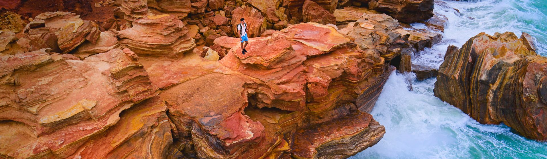 Aerial view of a person standing on the cliff edge of Gantheaume Point, Kimberley coast of Western Australia