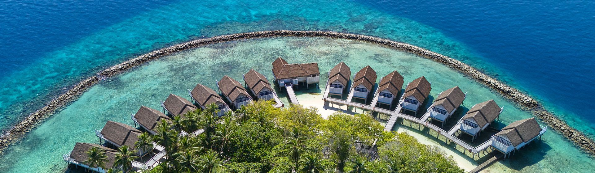 Aerial view of overwater bungalows at NH Maldives Kuda Rah Resort