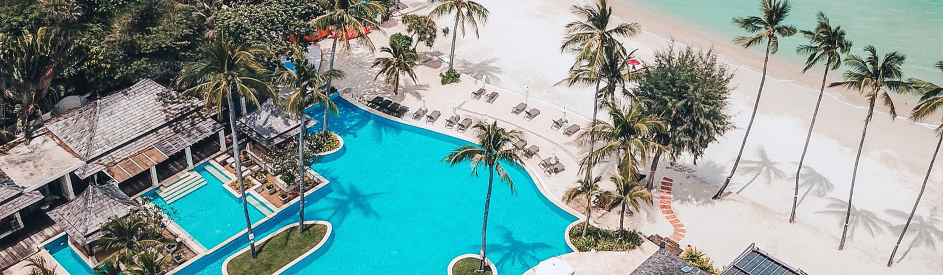 Aerial view of pool area adjacent to the beach at Melati Beach Resort & Spa, Koh Samui, Thailand