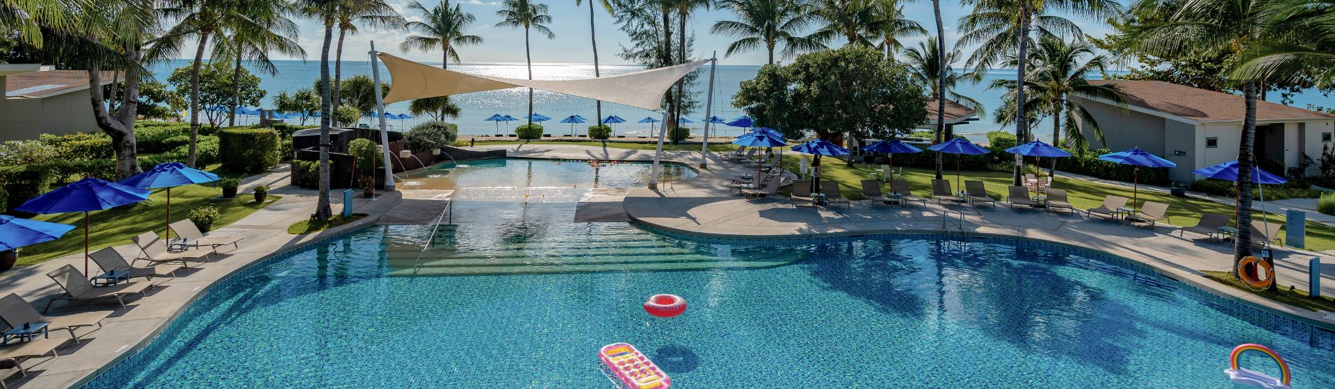 Aerial view of the pool at OZO Chaweng Samui with the beach in the background