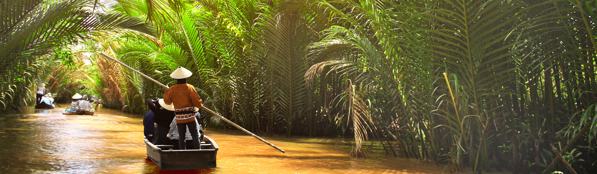A boatman paddling down the Mekong River in Vietnam
