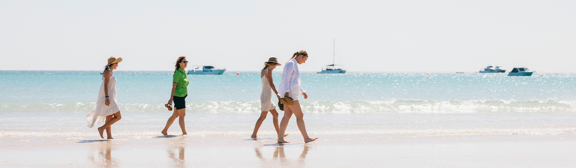 People walking along pristine beach during Broome Town Tour, Western Australia